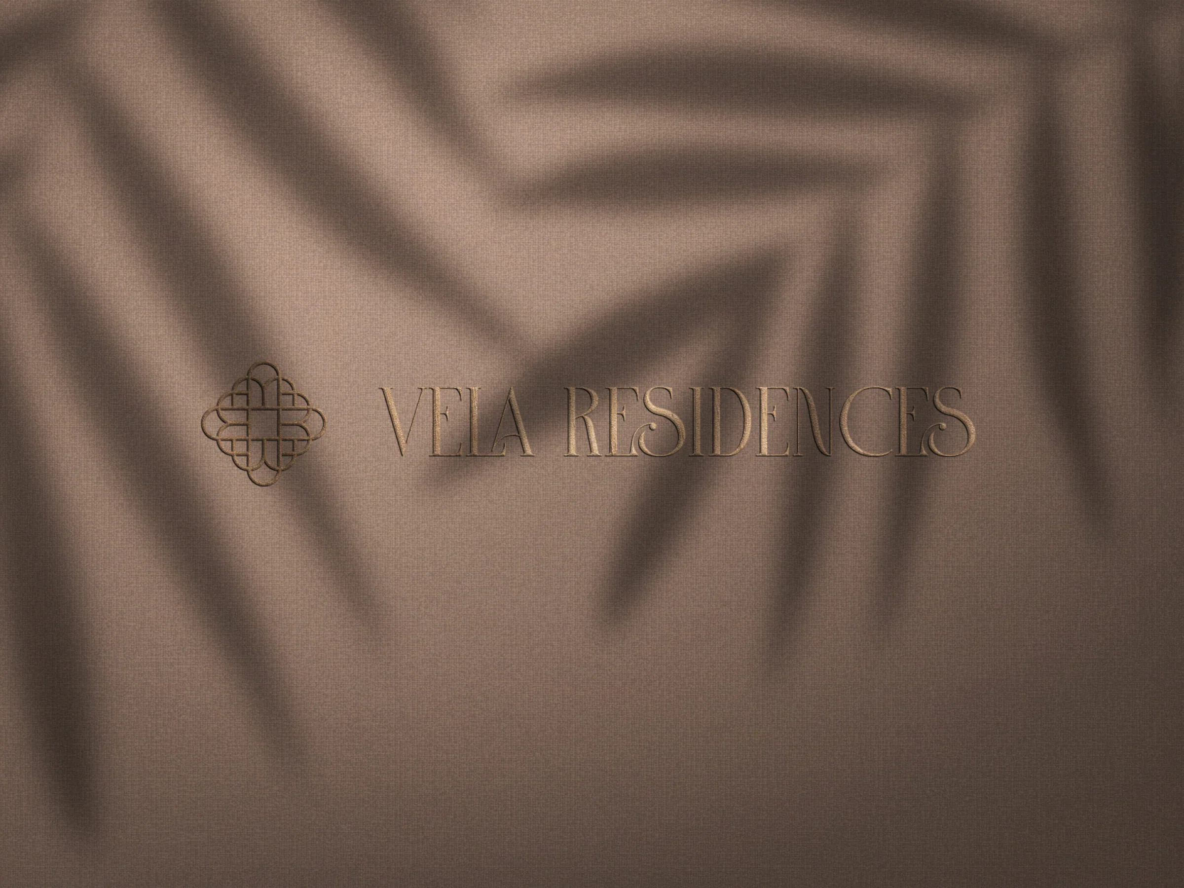 Logo VELA Residences so svetlom a tieňom paliem